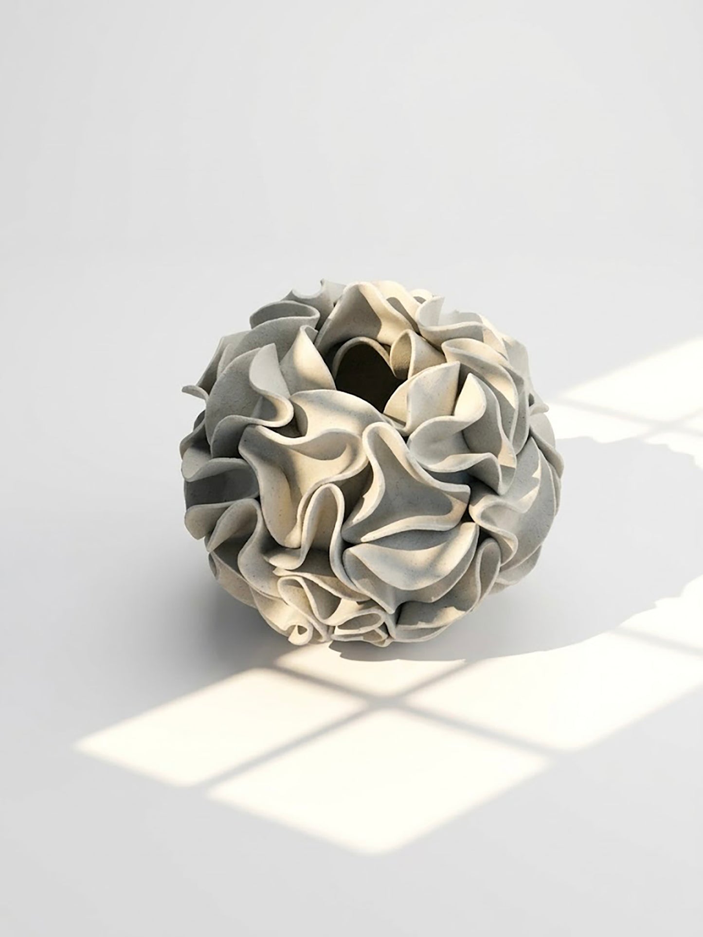 White clay ceramic flower vase sculpture with contoured edges