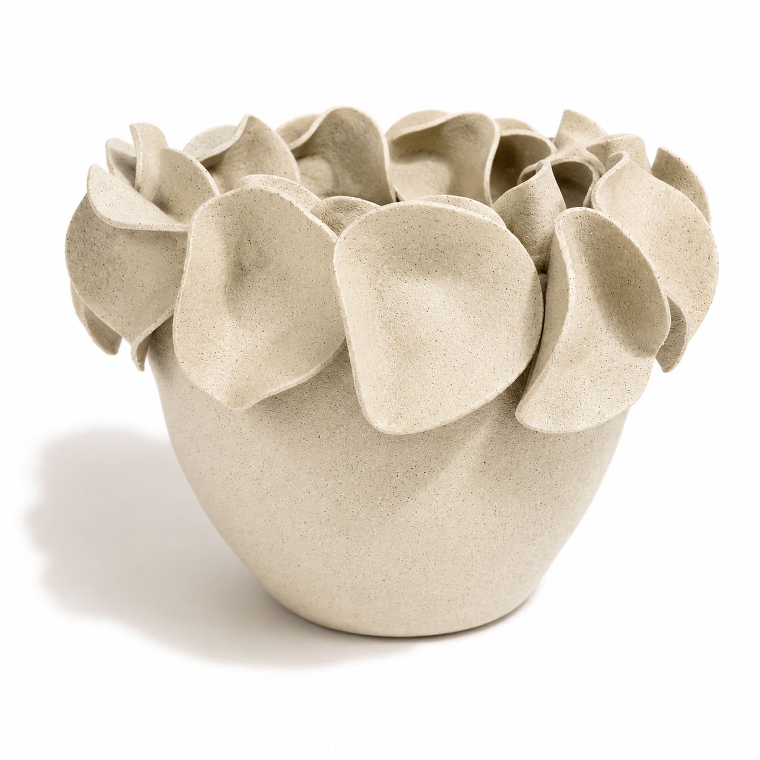 A sculptural ceramic planter with a textured, speckled light beige finish and layered, petal-like protrusions around the rim.