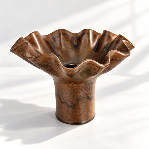 A decorative ceramic vase with a wavy, flared rim and a cylindrical base, finished in a chocolate-brown glaze with dark brown mottled areas