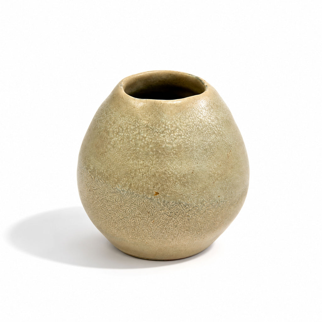 A small rounded ceramic vase with a textured, speckled glaze in a muted beige-clay colour, shown on a white background with a soft shadow.