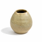 A small rounded ceramic vase with a textured, speckled glaze in a muted beige-clay colour, shown on a white background with a soft shadow.