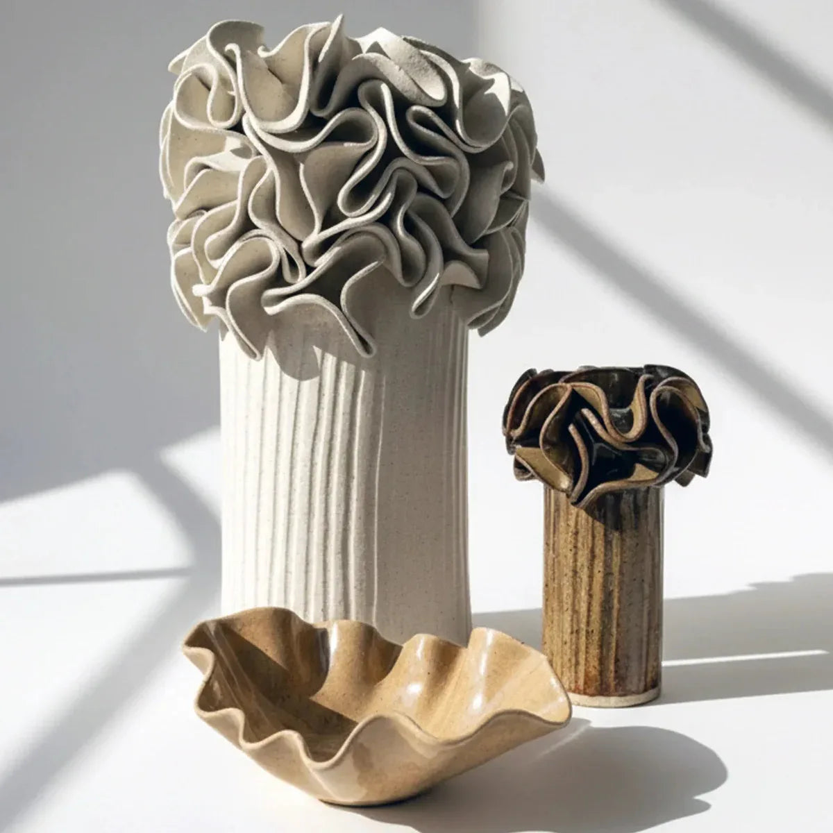 Three ceramic vases with unique ruffle designs